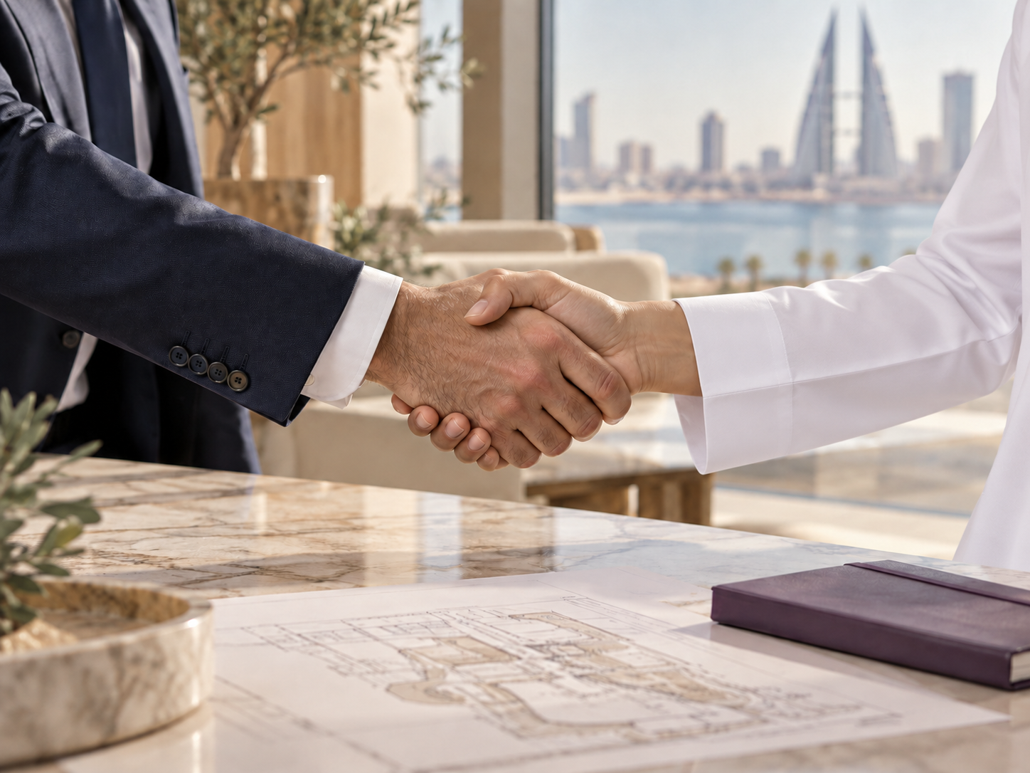 Handshake between a suited professional and a partner wearing a traditional white thoub